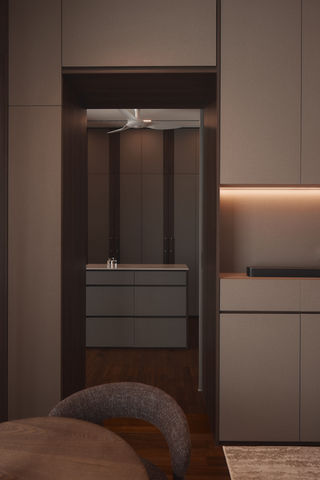 A master bedroom showing a bed and a transition into a private dressing or lounge area.