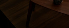 Atmospheric Modern Oriental tea corner with a low wooden table ceramic teapot and traditional tea cups.