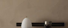 Dark Japandi fluted wood credenza counter featuring a paper shade table lamp and minimal coffee bar setup.
