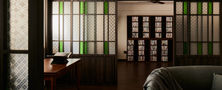 Modern Oriental interior layout with dark wood sliding screens opening up into a traditional tea drinking nook and display cabinets.