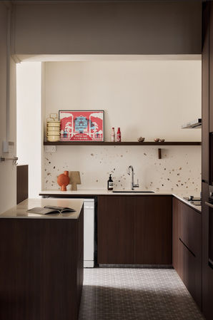 Retro-inspired kitchen design with terrazzo backsplash, textured tiled flooring, and bamboo-inspired details