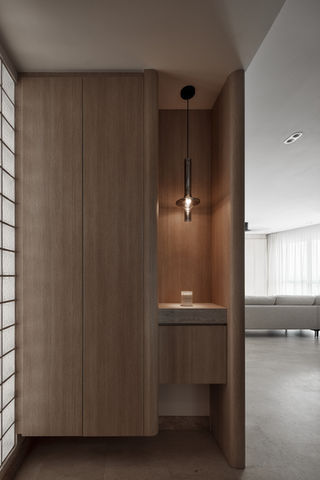 Japandi entryway design with light wood shoe cabinet and minimalist pendant lights