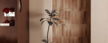 Illuminated wooden arched doorway feature wall with potted indoor plant herringbone parquet flooring and circular partition.