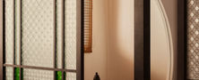 Architectural Modern Oriental living space featuring dark wood sliding screens leading to a traditional circular moon gate doorway.