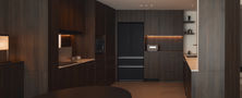 Open-plan modern kitchen and dining interior featuring seamless dark wood cabinetry, island counter, and ambient linear lighting.