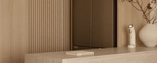 Light Resort Japandi kitchen peninsula counter set against a light timber fluted wall panel and built in refrigerator.