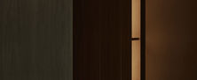 Architectural Dark Japandi hallway junction featuring dark charcoal timber panelling and warm concealed cove lighting.