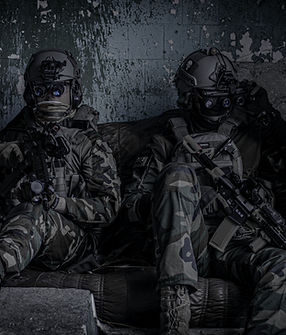 Airsoft players in protective glasses an
