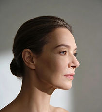 Side profile of a woman with her hair tied back