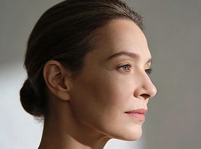 Side profile of a woman with her hair tied back