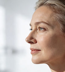 Side profile of a mature woman with grey hair
