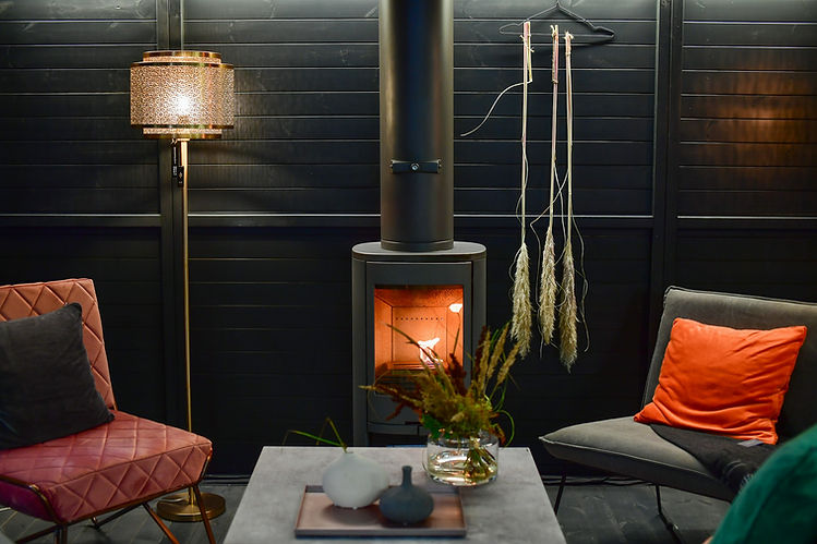 Softly lit lounge with a wood-burning stove
