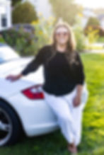 headshot of {sb} looking professional with pink glasses