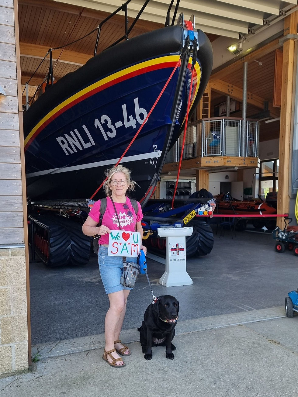 Mum Rachel and Daisy dog proudly in front of the new RNLI 13-46 lifeboat featuring Sam's name