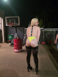 Woman in lingerie at a bucks party event outdoors.