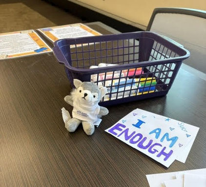 Plush Wolf in "Walpole Prevention Coalition" branded t-shirt in front of craft table at "Back to School Reset" event