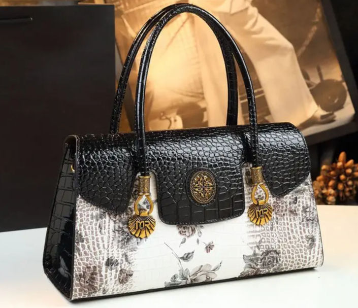 Elegant black and white handbag with floral accents