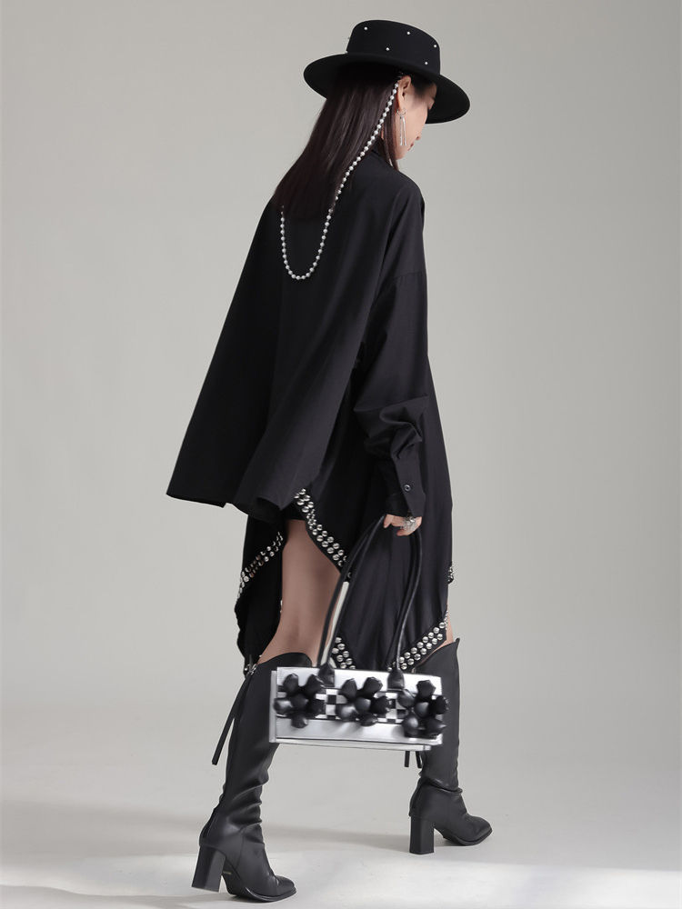 Model in black asymmetrical shirt dress and boots