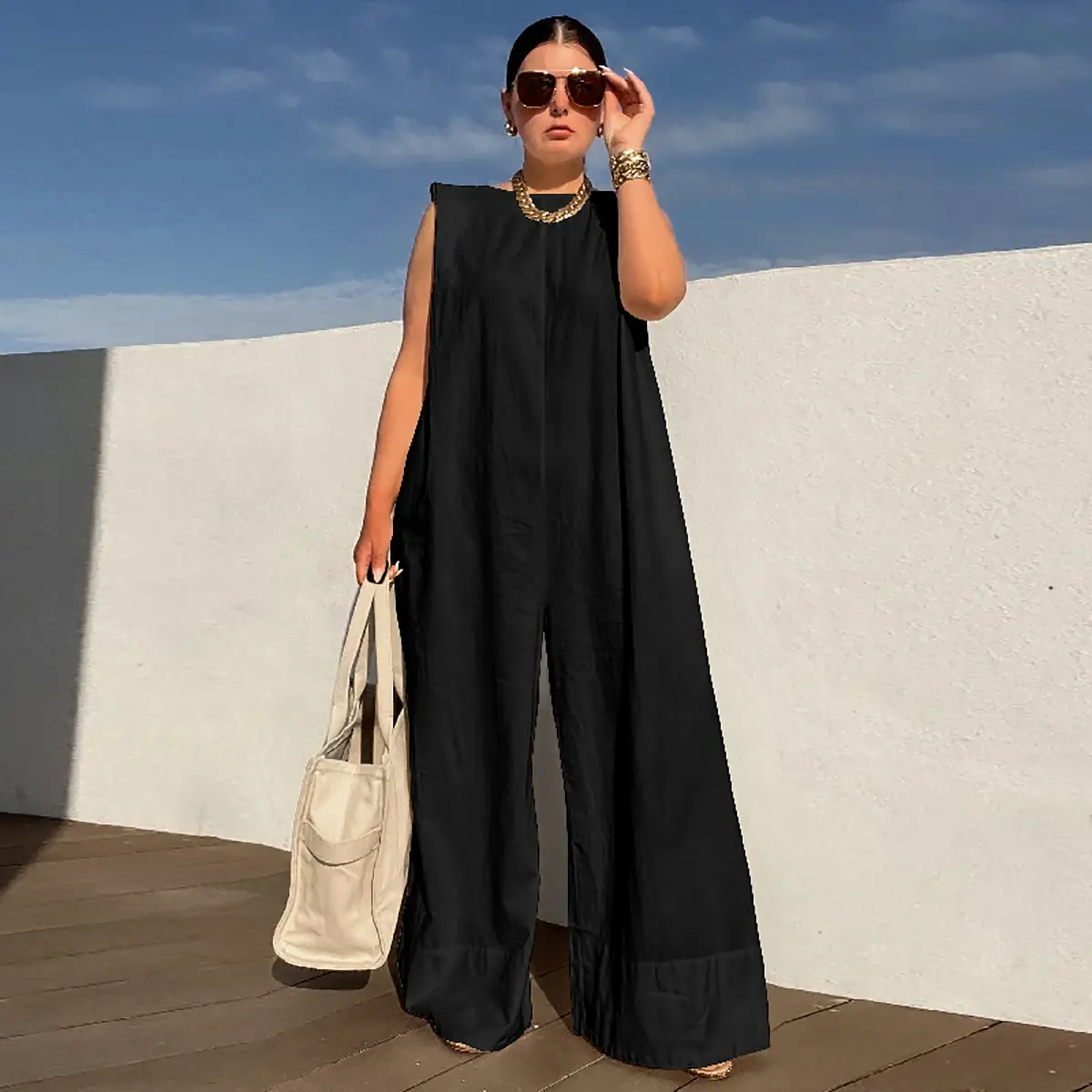 Woman in stylish black jumpsuit