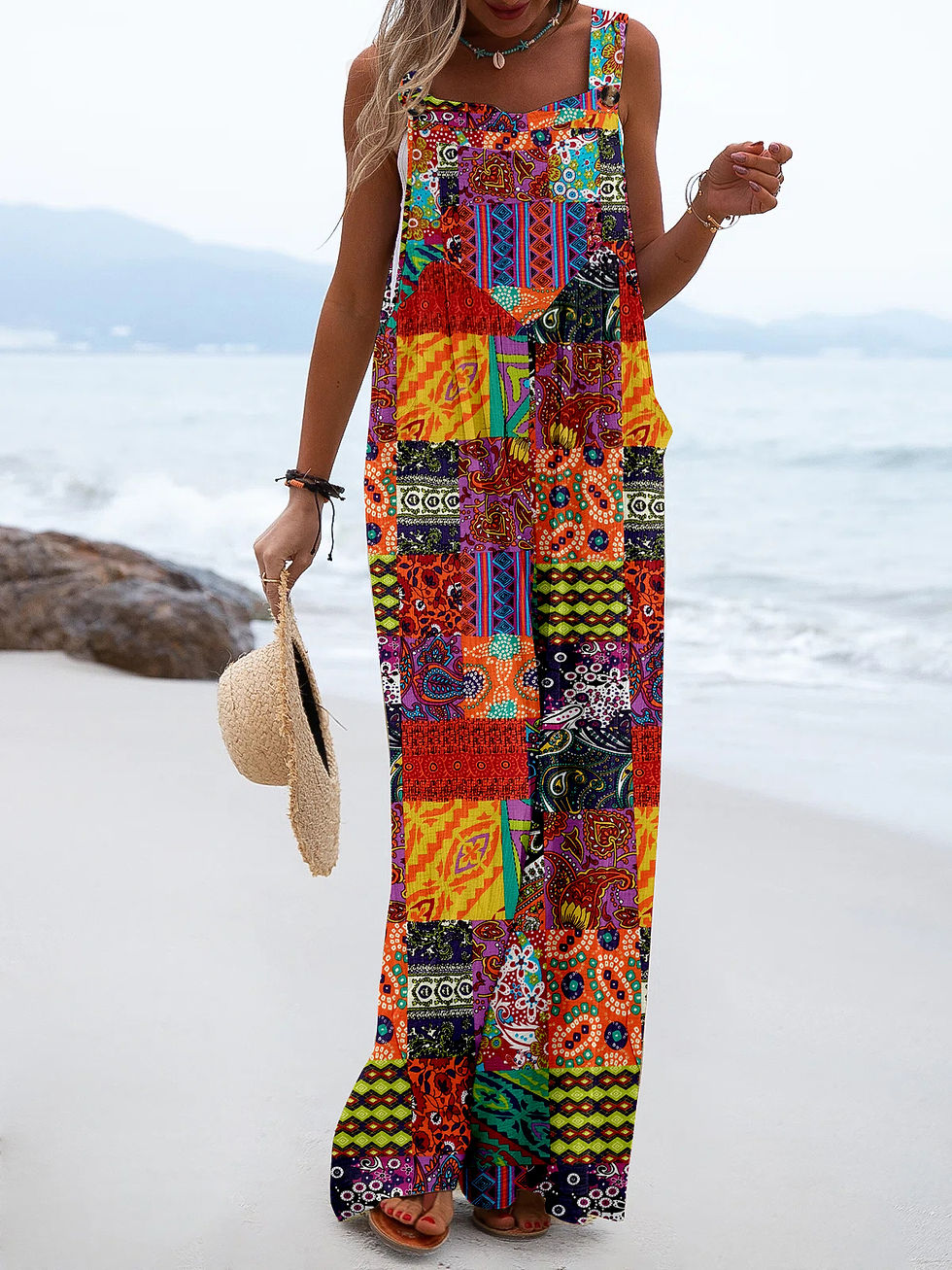 Woman in colorful patterned maxi dress on beach