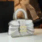 Elegant white handbag with unique buckle detail