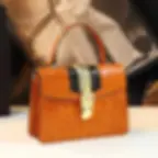 Orange crocodile-embossed handbag with gold clasp