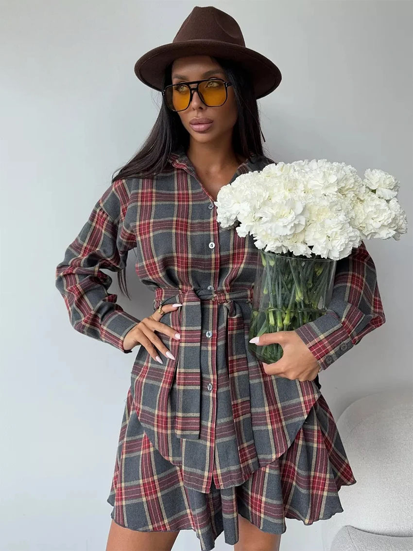 Model in red and gray plaid dress