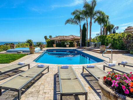 The elegant pool area of Passages Malibu sober living home.