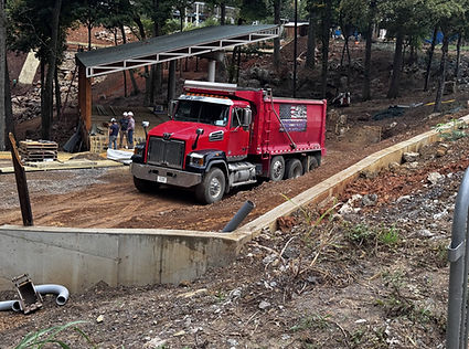 Dump truck delivering gravel and topsoil onsite in White Pine, TN from West Dumplin Valley Farms.