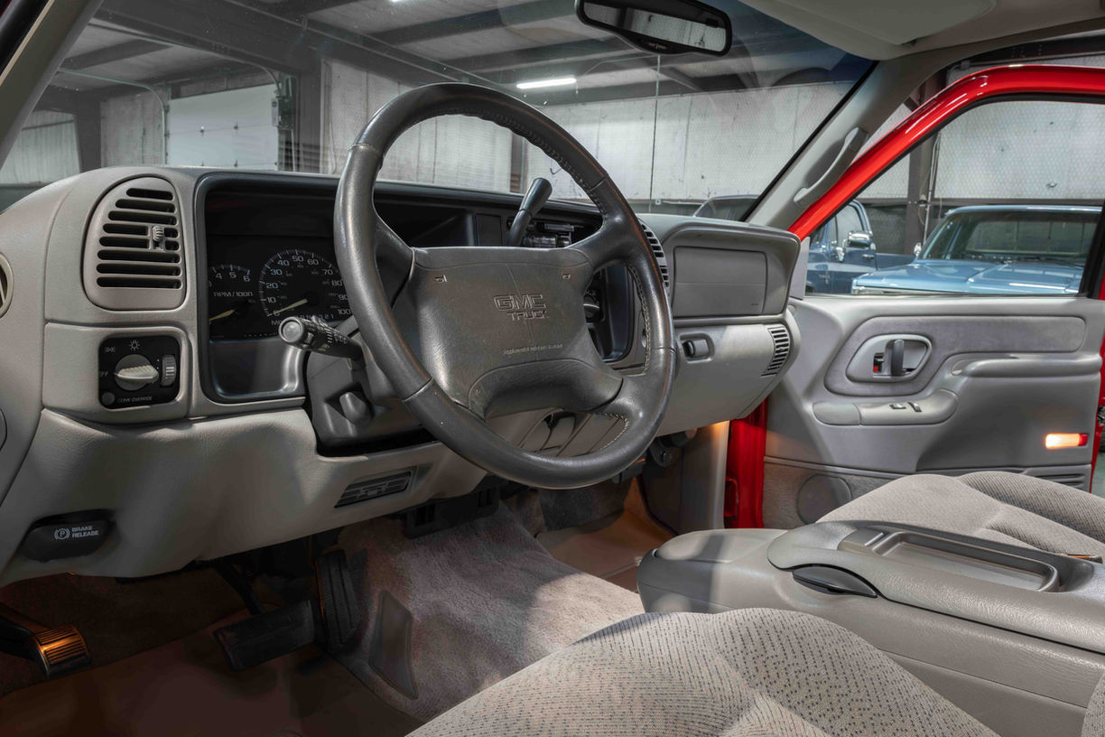 1997 GMC K1500 finished in FireRed and QuickSilver two-tone with factory fuel-injected 350 and automatic transmission