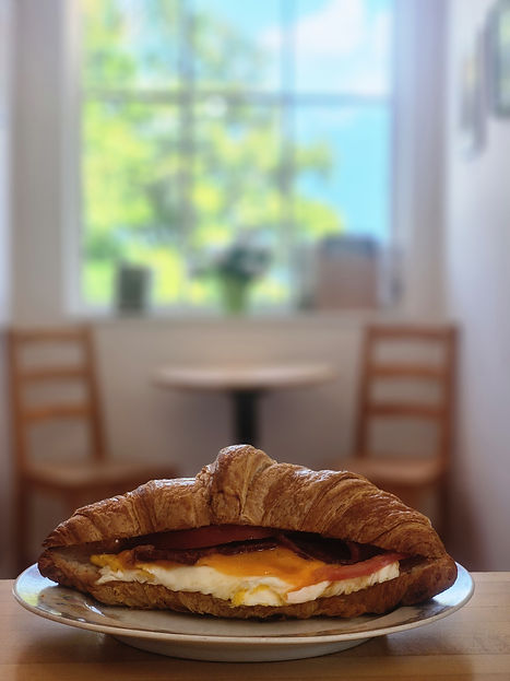 photo of Hazey Daze Parlour's croissant breakfast sandwich with egg, cheese, bacon, tomato and mayo