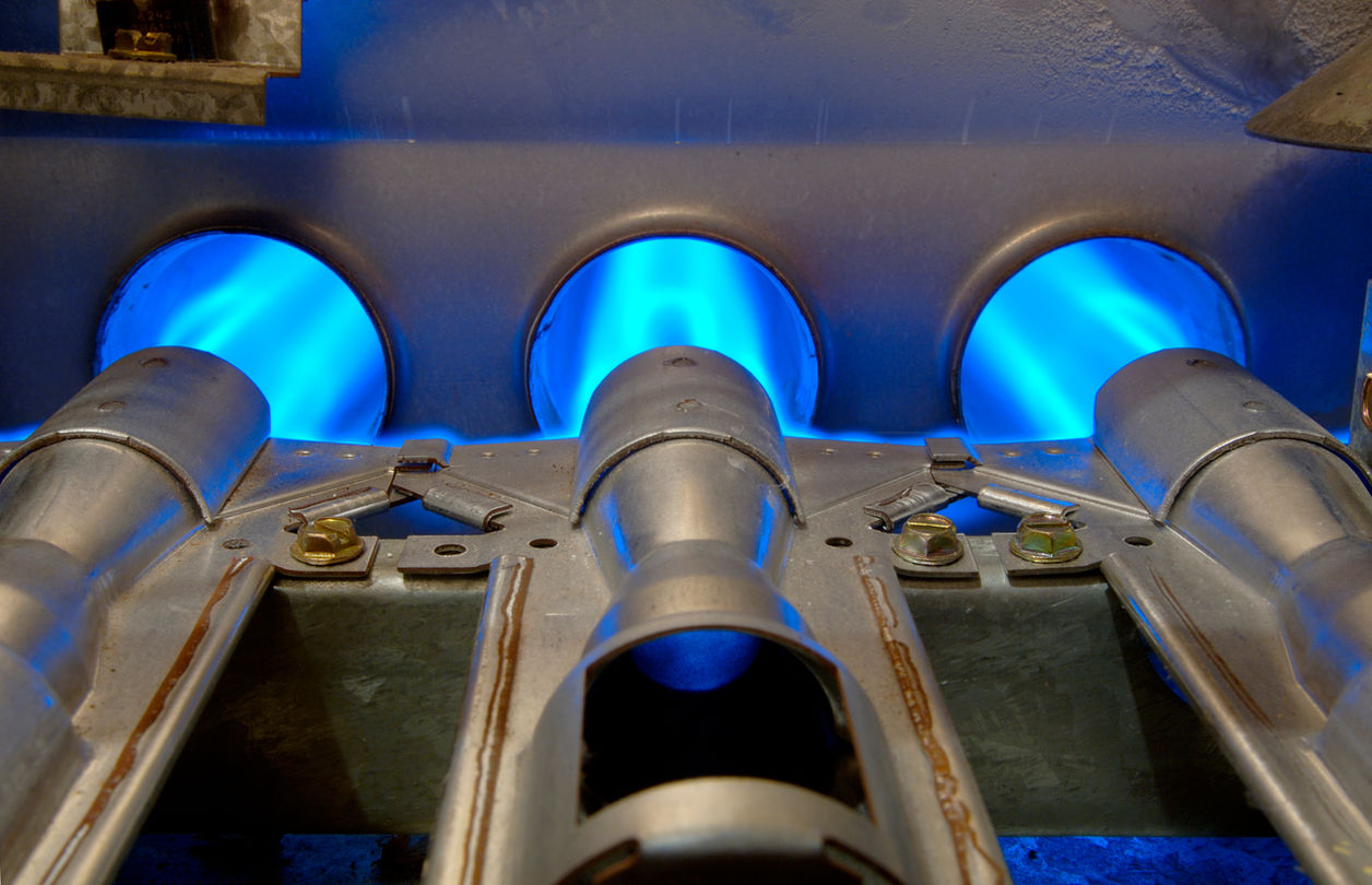 kitchen burners lit with blue flames