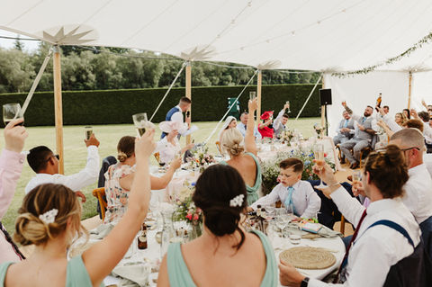glasses raised in Hampshire marquee wedding during speeches