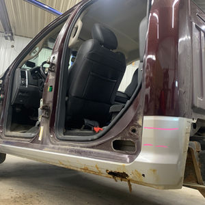 Before photo of a rusted rocker on a pick-up truck..