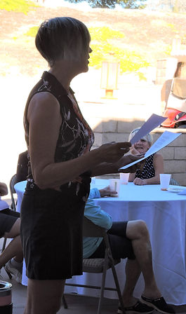 Lori reading golf poem.JPG