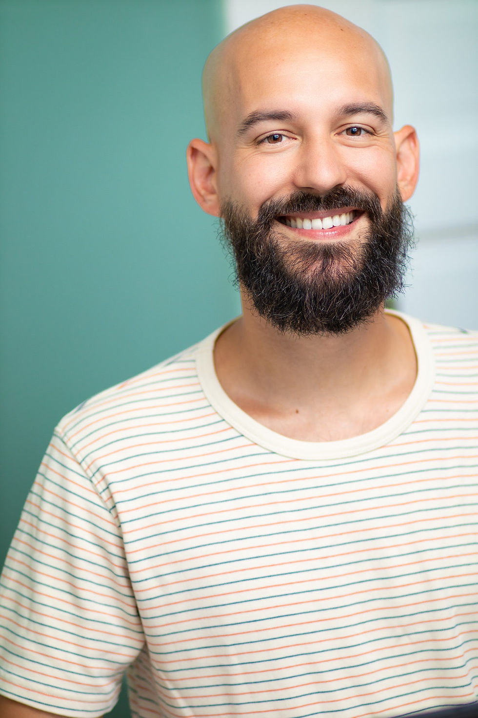 headshot photograph of man in striped shirt