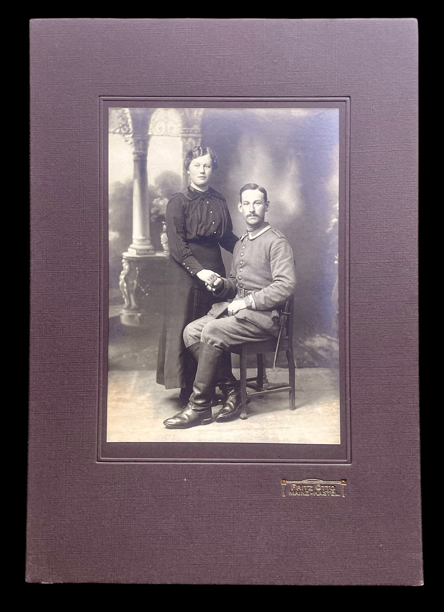 WW1 studio photo of soldier and wife, butcher bayonet on his waist.
