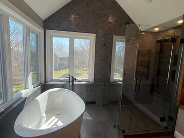 Luxury master bathroom renovation with marble shower and freestanding tub
