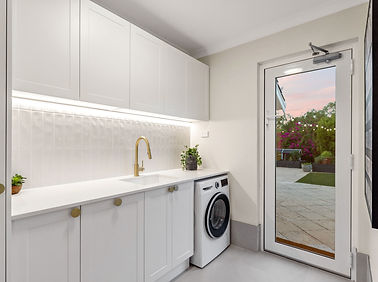 Open shelving and bright LED lighting installed during a laundry renovation project
