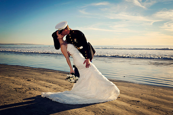Military couple reaffirming their vows at the coast on the Coronado Beach.