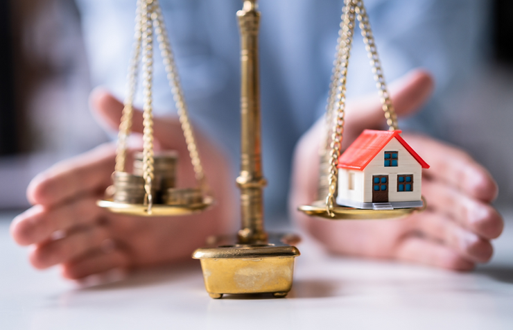A SCALE BALANCING A STACK OF COINS (REPRESENTING CASH/LIQUID ASSETS) ON ONE SIDE AND A MINIATURE HOUSE (REPRESENTING REAL ESTATE/LONG-TERM INVESTMENTS) ON THE OTHER, SYMBOLIZING THE IMPORTANCE OF BALANCING DIFFERENT ASSET TYPES FOR RETIREMENT.