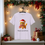 Thumbnail: Unisex organic cotton t-shirt featuring Ramble the kitten in festive attire, surrounded by holiday-themed elements.