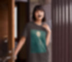 A woman with black lipstick standing in a doorway wearing a black t-shirt with the moon on it.
