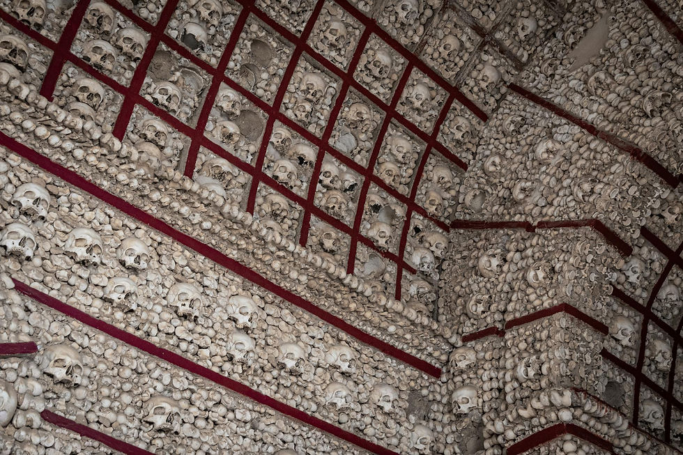 Walls and an archway lined with human bones and skulls
