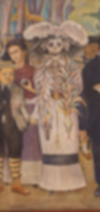 Mural with frida kahlo and diego rivera standing near calavera figure in a large hat and feather boa.