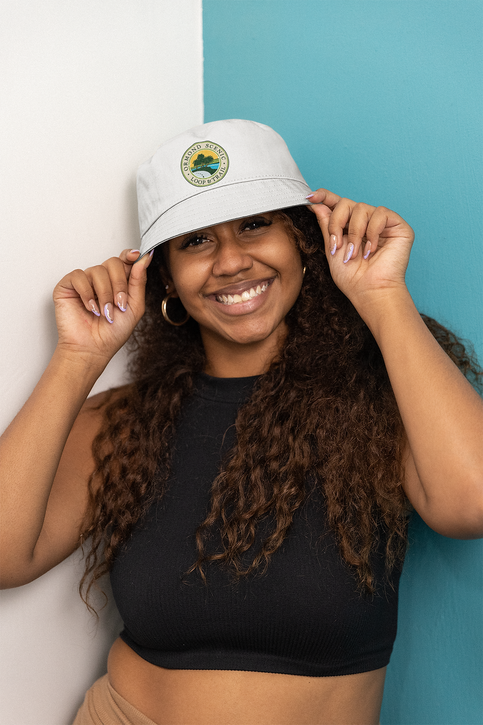 woman wearing white bucket hat with oslt logo