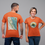 Thumbnail: Man wearing orange t-shirt with OSLT map on back with woman wearing OSLT logo on the front of orange shirt