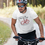 Thumbnail: Man riding bike wearing white shirt with ride the loop OSLT logo