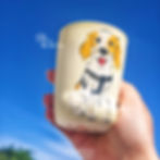 Hand-painted ceramic mug with a cartoon dog design in blue shirt by Paw Paw Tree