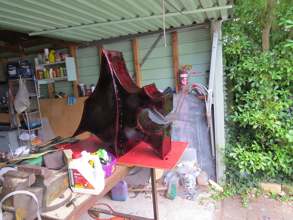 Head of Emrys the Great Welsh Dragon under construction, developed first in cardboard then recreated in panel steel and painted red ready for the copper scales.
